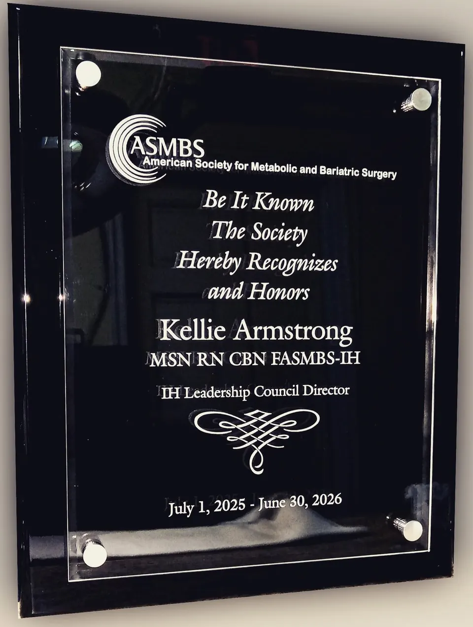 Black acrylic floating plaque recognizing a society member