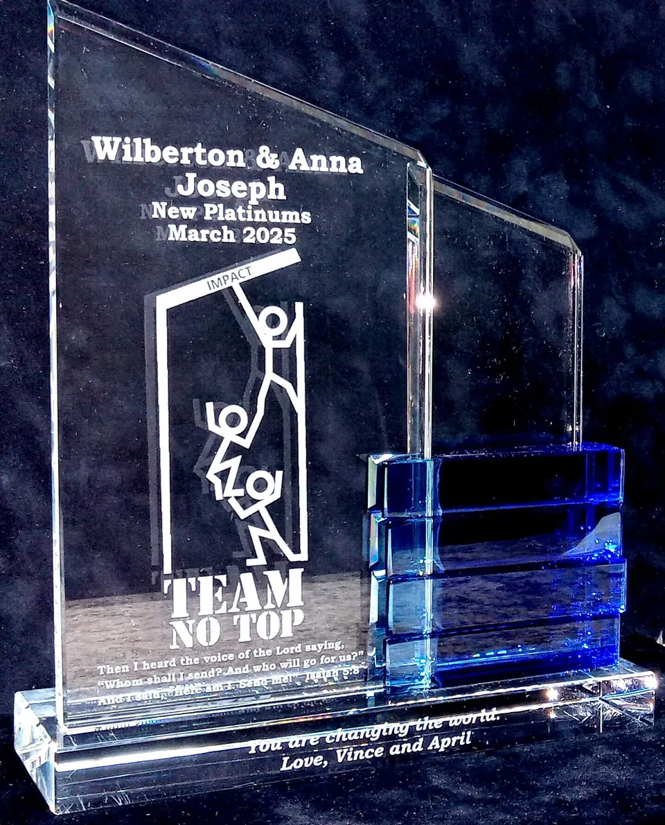 Clear acrylic team award with a blue accent and engraved illustration