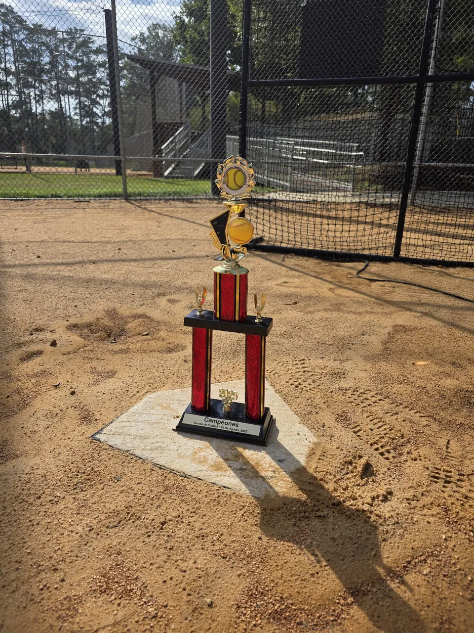 Tall red column baseball trophy standing on home plate
