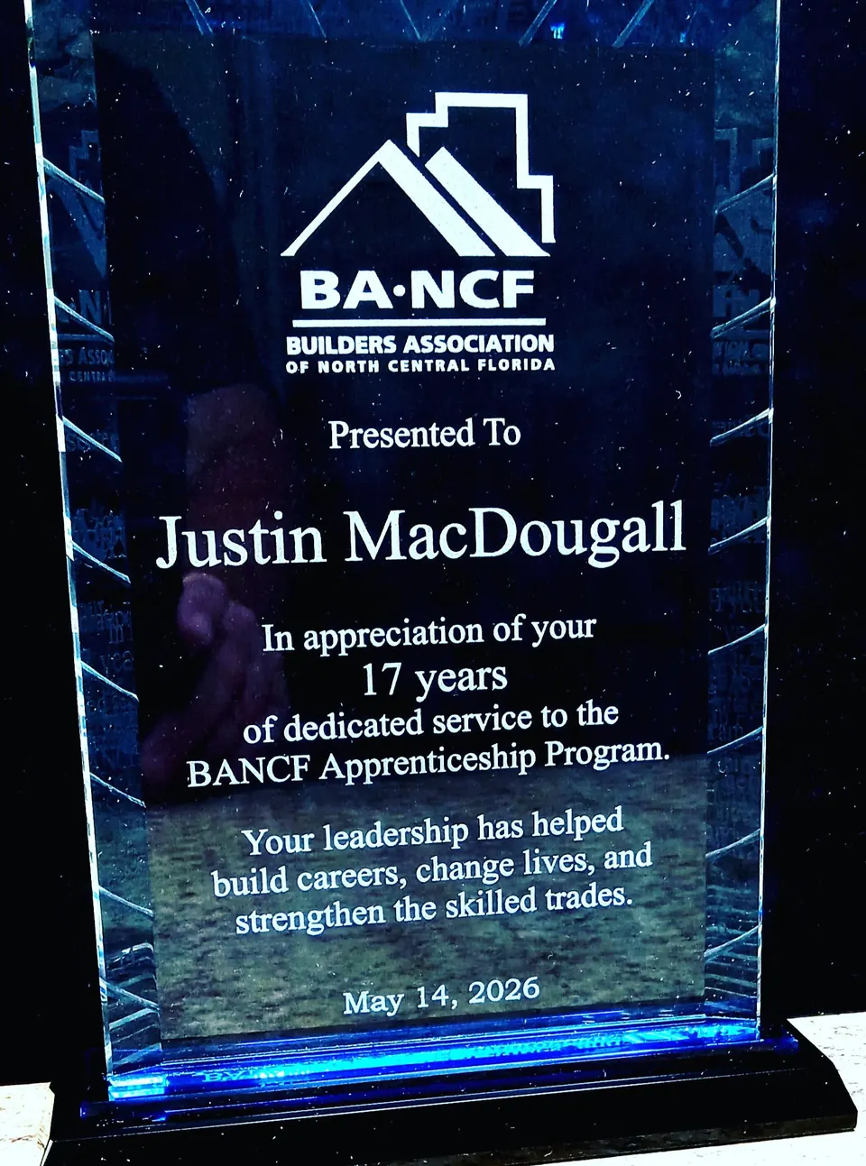 Tall blue-edged glass appreciation award with engraved tribute text