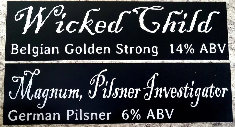 Black engraved beer name signs for a brewery