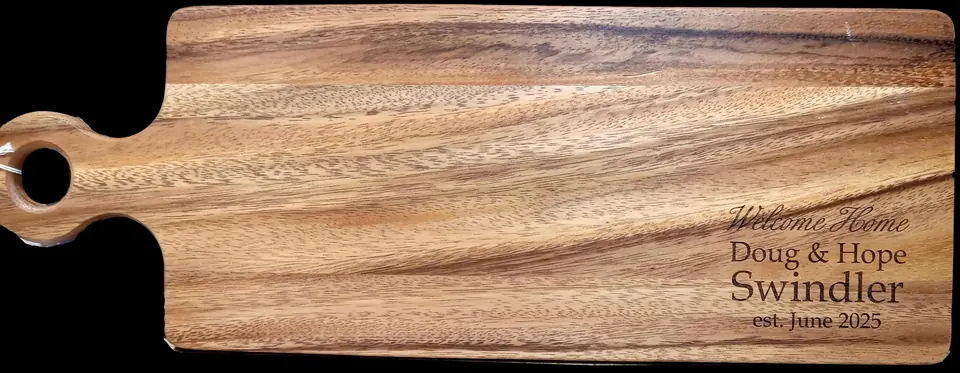Wood charcuterie board engraved with a couple's names