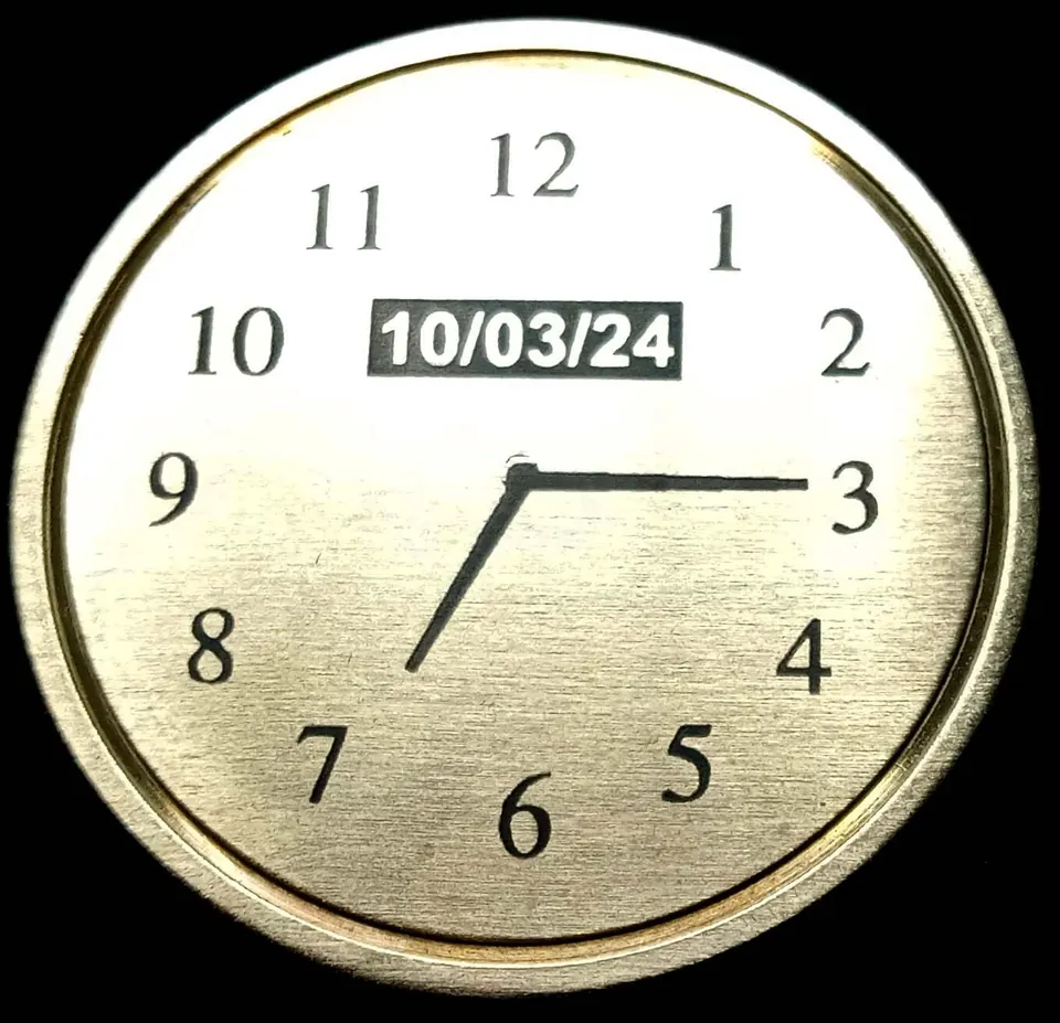 Brass clock face engraved with a special date