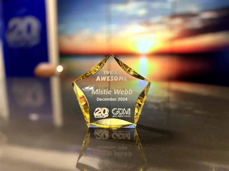 Gold-tinted crystal star award photographed at sunset