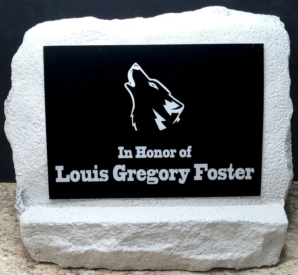 Memorial stone with a black engraved In Honor Of plaque